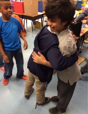 A classmates hugging each other in school