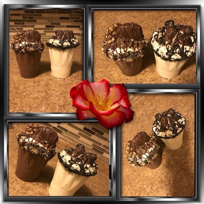 Chocolate cups filled with cake layers and cookies and candies