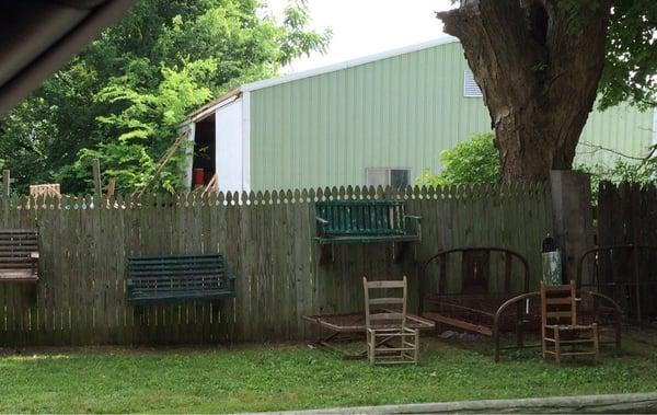 Up against the fence are these chairs and 2-seaters.