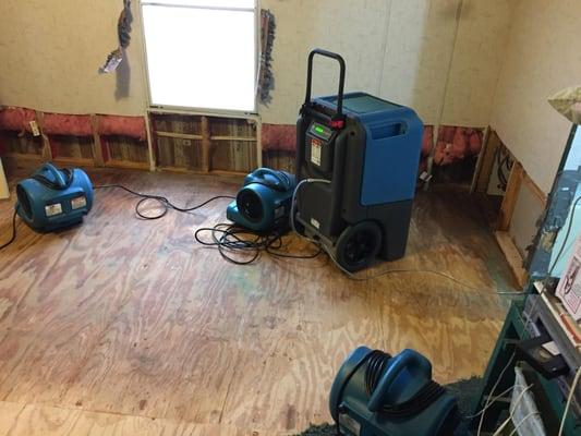 Machines set to dry wet floor and walls