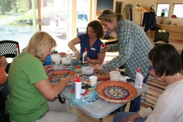 Hard at work on their birdbaths at a mosaic birdbath workshop