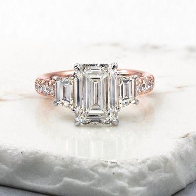 Emerald cut engagement ring with trapezoid side diamonds.