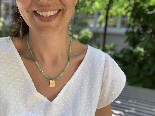 Saskia wears the green chrysoprase in the courtyard of Industry City.