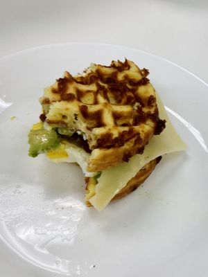 Keto breakfast chaffle with egg, bacon, cheese, avocado & mayo