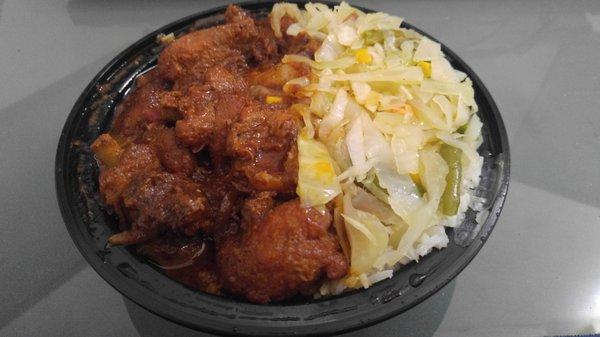 Brown Stew Chicken over rice with cabbage, onion, green bean, and corn on the side. Tasty!