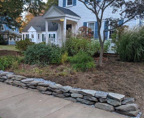 We built a 20 ft long dry rock wall for this client. Scape and Stage gardening and home organization