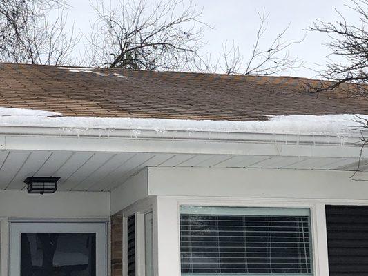 Snow removed from roof, but ice dam remains.