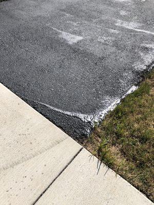 Sloppy job sealing the driveway.