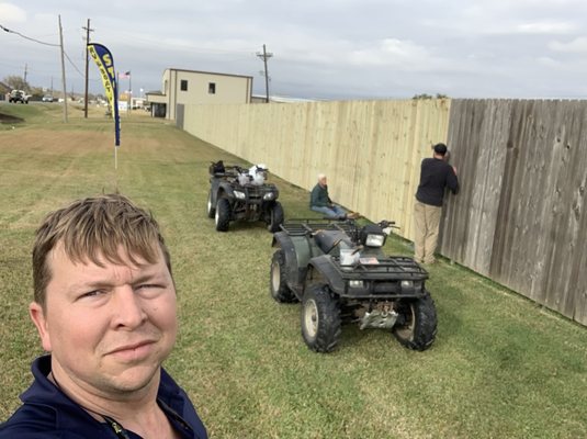 The owners repairing the fence damaged in hurricane.