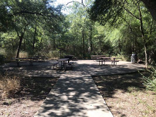 There are a at least two pavilion areas that have about 6 benches and grill.  Could accommodate 35+ people.