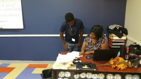 Invictus High School teacher goes over a student test results at the east Cleveland campus