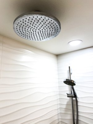 Rainfall shower head and bathtub done by our remodeling team during a whole bathroom remodel.