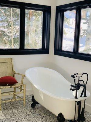 Clawfoot tub, cool tile, and black window frames in this sweet bathroom we built in Edwards, CO.