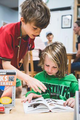 Two elementary students working together in the library.