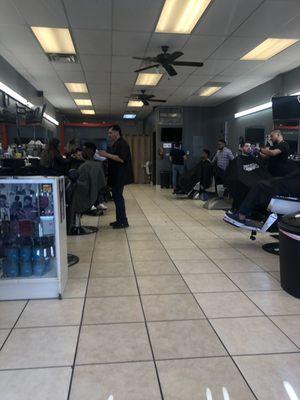 Barbers coming from back ignoring sign in sheet and clients waiting, they sat only their friends who were in the back hanging out with them