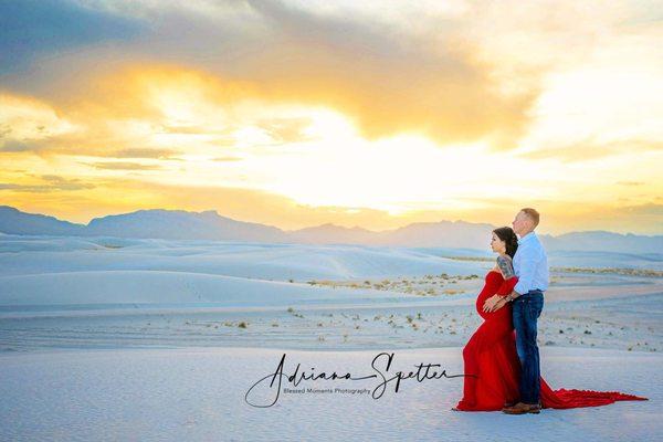 Maternity photo at White Sands National Park shot at sunset with red gown