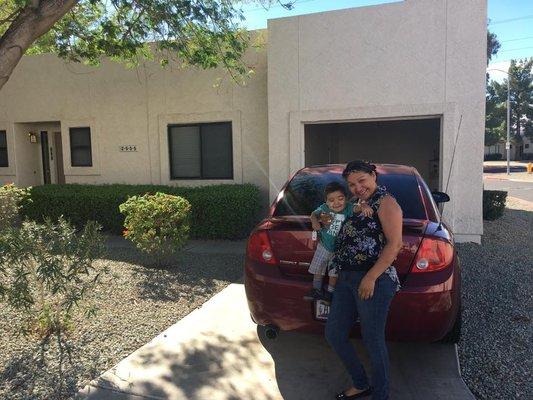 Recent happy Mortgage Experts clients in front of their new home.