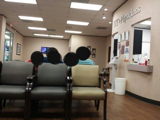 Spacious waiting room with plenty of chairs.