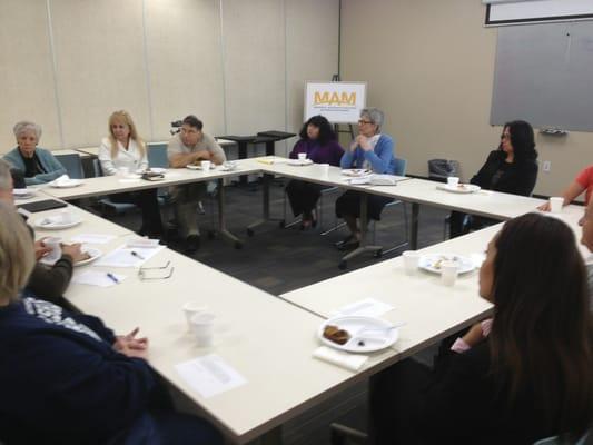 MAM clients and volunteers participate in a Prayer Breakfast led by the clergy of one of MAM's 30 member churches.