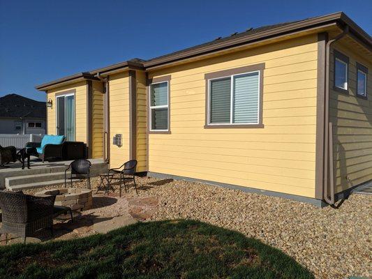 Back of the house that had a lot of cement over spray and areas where the dogs chewed the siding. Looks brand new.