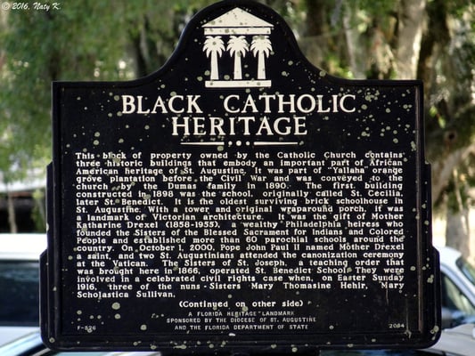 Historical plaque on the grounds, detailing the black Catholic heritage and the church's origins.