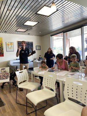 Cleveland Metroparks naturalist talking about and showing live owls for our Art and Owls event where guests sketched and colored.