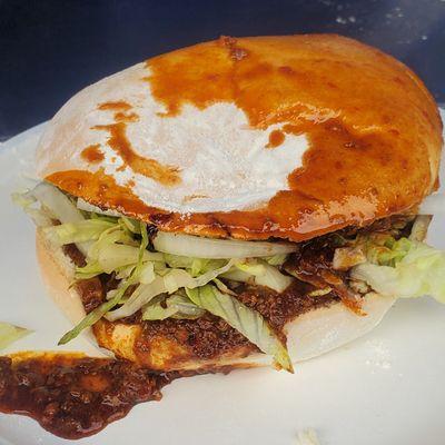 Pambazo: braised ground beef sandwich with chorizo, in a bun dipped and fried in a chile sauce.