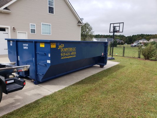 Dumpster delivered and ready to be filled. Just open the back door and walk your heavy items inside.