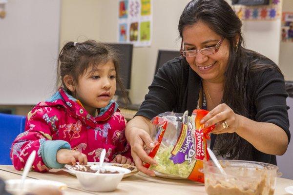 Mother and child eating at parents' night.