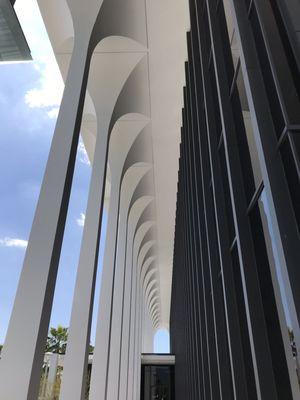 You can see the juxtaposition between the black iron of the building side itself and the white arches attached to the side.