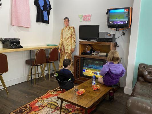 Kids playing vintage video games inside Happy Hour Vintage.