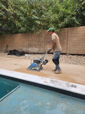 Compacting rock base for turf installation