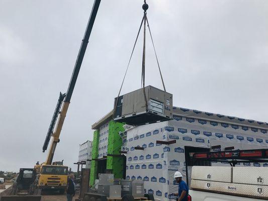 Setting units on the roof of new Jiffy Trip on the corner of Owen K. Garriott and Cleveland.