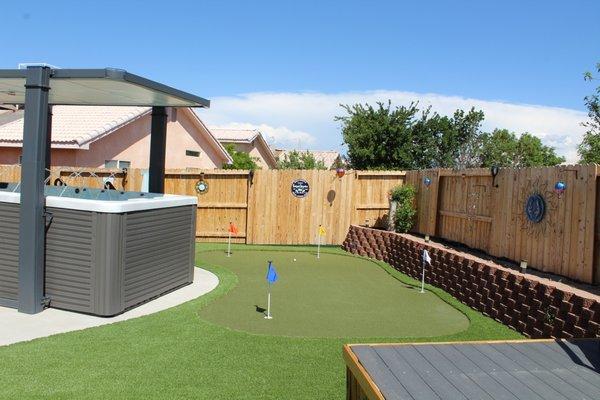 Putting green, concrete slab, and retaining wall, all done by SynLawn.