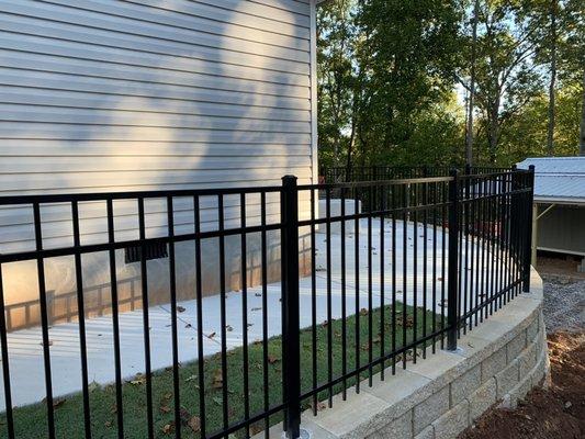 This retaining wall, custom concrete work and handrail added unbelievable value to this lakefront home.