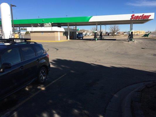 Full gas station with 16 regular pumps and 8 more truck pumps behind.