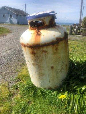 This is the rusty propane tank Amerigas won't pick up from in front of a house I bought after 3 months ans they say 4 months wait