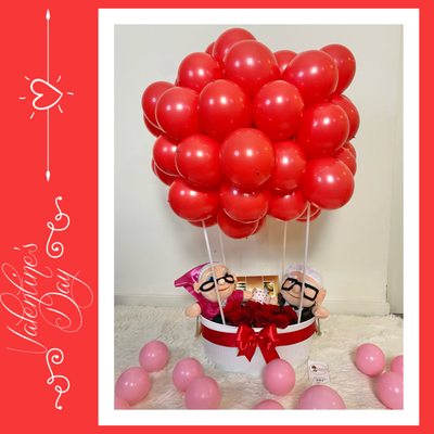 Hot air balloon design with "UP" movie characters, chocolates and roses.