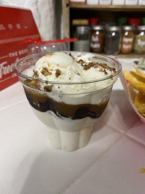 "Large sundae with whipped cream and nuts"