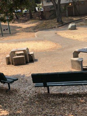 Benches, children's play area at left