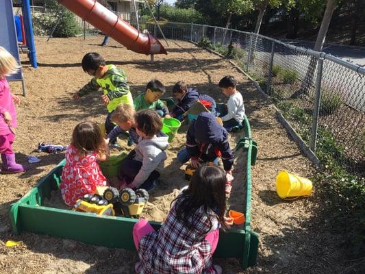 Sandbox play, a favorite outdoor activity!