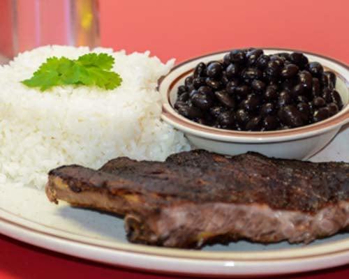 White rice , black beans and chuleta frita