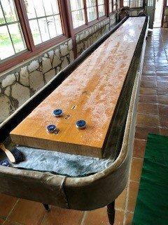 Shuffleboard in one of the many games in our large Game Room