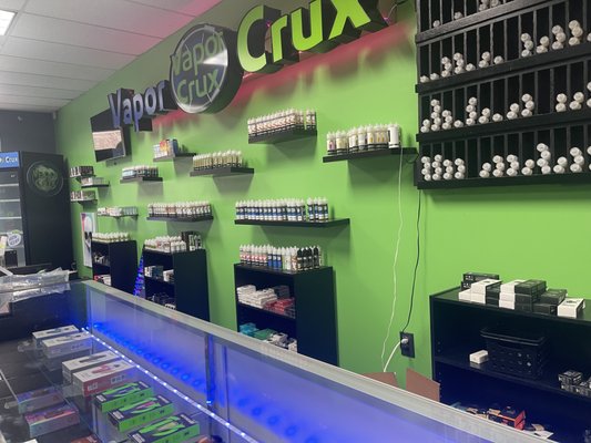 Our Juice wall under our Vapor Crux Sign