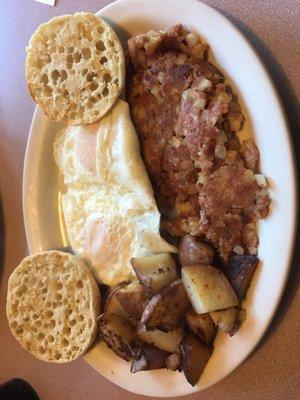 Eggs over easy with corned beef hash and English muffin