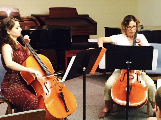 Emily playing a duet with an adult student