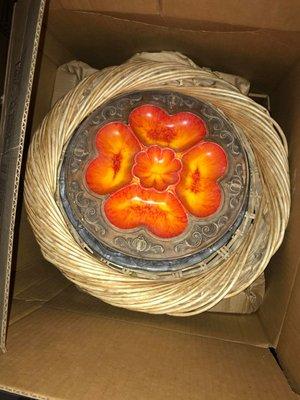 The ceramic tray is on top of a glass one just thrown in a box with more items piled on. The glass was cracked as a result.