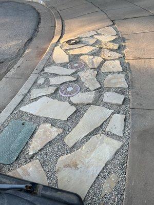 2" Sunset flagstone with pea gravel between on sidewalk strip.