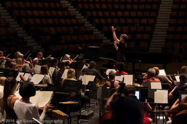 Maestro Daniel Stewart conducting at rehearsal (photo by Joe Ravetz)