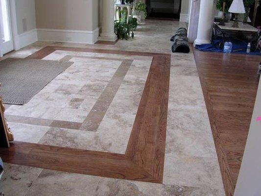 Entry way with natural marble and hadwood floor, good combination.